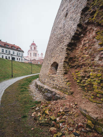 A closeup shot of The Bastion of the Vilnius Defensive Wall in Vilnius, Lithuania with buildings in the backgroundの写真素材