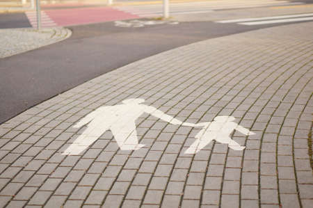 A high angle shot of road signs on the ground for cyclists and pedestrians