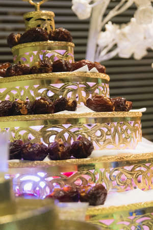 A vertical closeup shot of Asian sweet snacks on a tray in the shape of a wedding cake