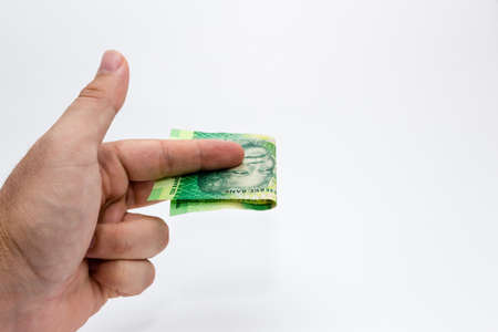 A closeup shot of a person holding some cash over a white background