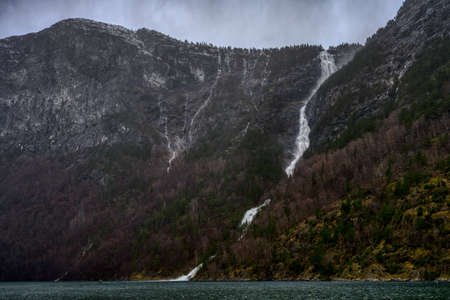 A natural waterfall on the Naeroyfjord mountain in Norway
