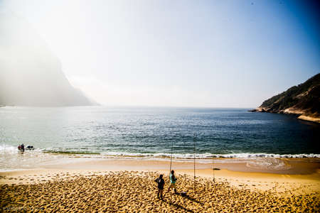 A beautiful beach and people fishing in Brazil Urca Rio De Janeiroの写真素材