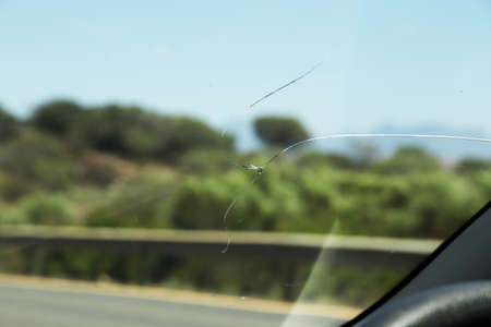 A closeup shot of a cracked car glassの写真素材
