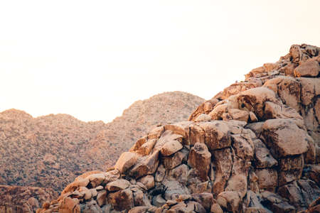 A landscape of rock formations under sunlight in a deserted area