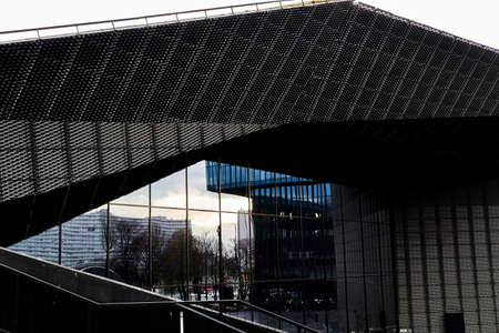 Reflection of buildings in the angular glass facade of another building.