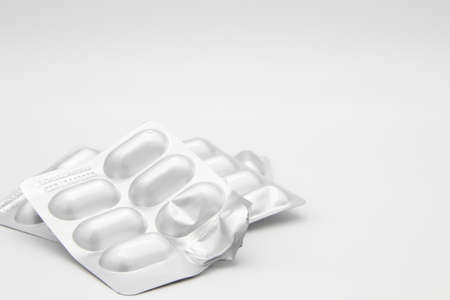 Medication in the form of capsules/pills/tablets against a white background