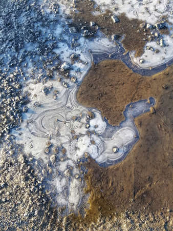 A vertical closeup shot of water and sand on the beach in Larvik, Norway