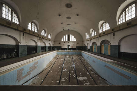 The empty swimming pool inside an old abandoned buildingの写真素材