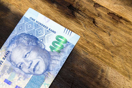 A high angle closeup shot of some cash on a wooden surfaceの写真素材