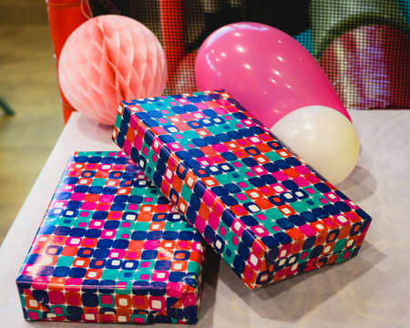 A high angle shot of packed gifts and balloons on the table
