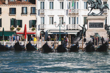 A beautiful shot of boats near the shore and buildings at Venice Italy Canalsの写真素材