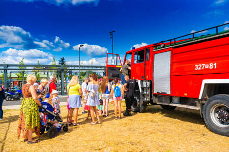POZNAN, POLAND - Jun 03, 2019: People standing by a exposition fire truck during a event.