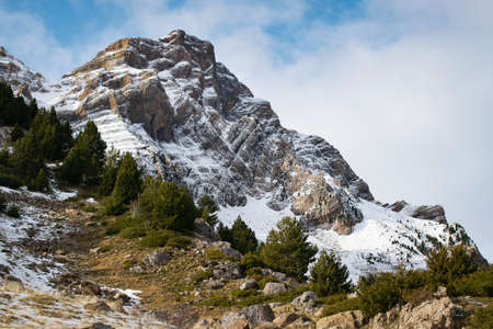 A beautiful mountain range covered with snow enveloped in fog - great for a natural wallpaper