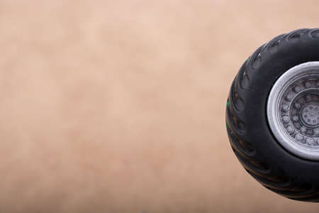 A closeup shot of a small black wheel with a blurred background