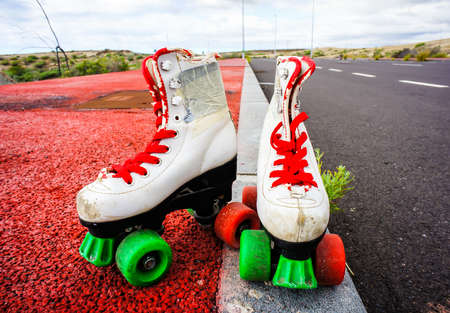 A closeup shot of white skating shoes in the road with a blurred backgroundの写真素材