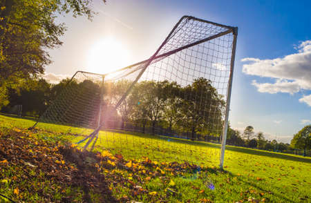 A low angle shot of a football net in the field on a sunny dayの写真素材
