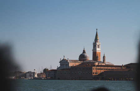 A selective focus shot of buildings in the distance in Italy Venice Canalsの写真素材