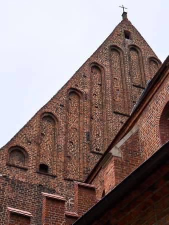 A church in the city of Krakow, Poland with a brick facade and geometric elements like arches.の写真素材