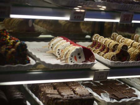 The trays full of delicious ice creams and cookies in the fridge of a shopの写真素材