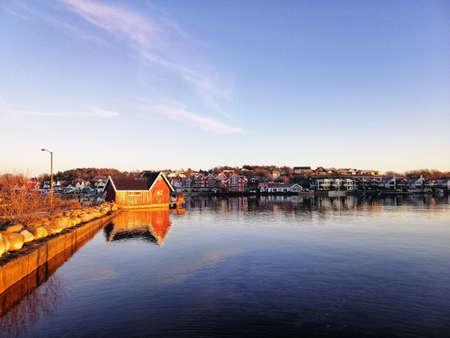 A mesmerizing scenery of buildings reflecting in the lake in Ostre Halsen, Spain