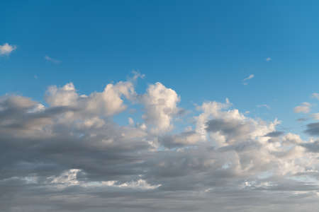 A beautiful blue sky with white clouds hanging