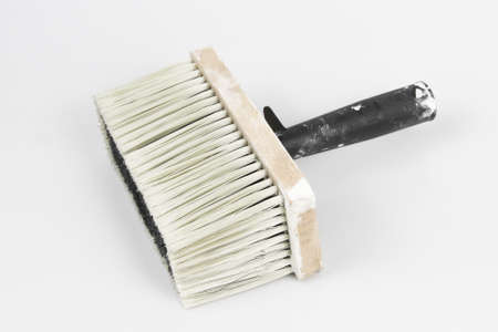 An overhead shot of a large size fence brush with a white-colored surface in the backgroundの写真素材