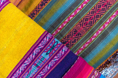 A high angle shot of the beautiful and colorful handcrafted fabrics in a market