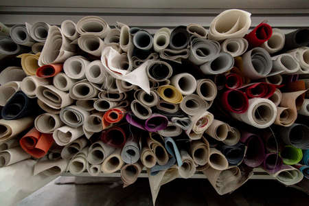 A lot of colorful textile rolls in a textile factoryの写真素材