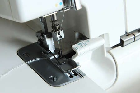 A closeup shot of a white sewing machine