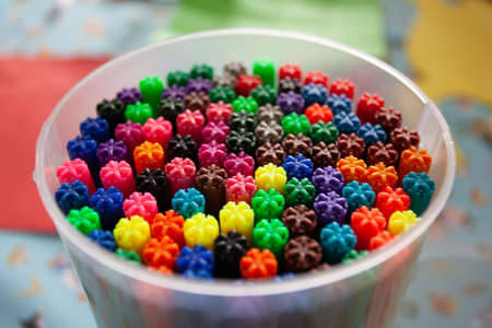 A selective focus shot of different color markers in a plastic jar