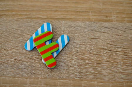 A closeup shot of striped words on a wooden surfaceの写真素材