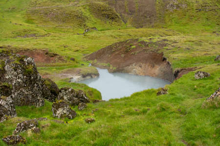 A beautiful view of boiling water in a geothermally active area in high mountains of Icelandの写真素材