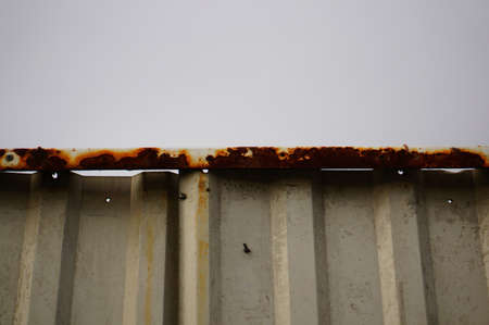 A closeup shot of a metal fence with bolts