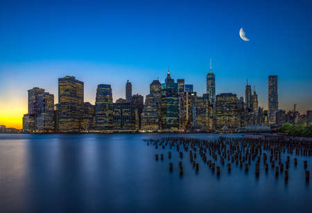 The evening Manhattan skyscrapers and water with reflection in itの写真素材