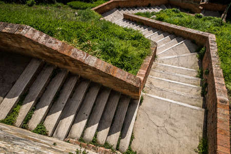 An overhead shot of stairs up the grassy hill at daytimeの写真素材