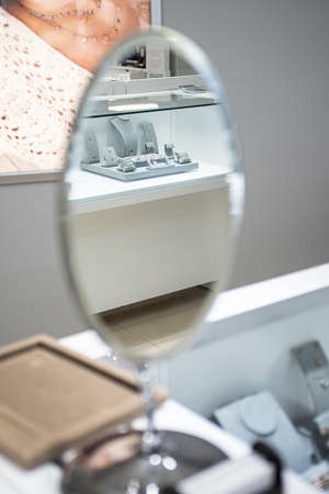 A vertical shot of a silver mirror on a dresserの写真素材