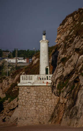 A vertical shot of a tower near a cliff in Santander, Spainの写真素材