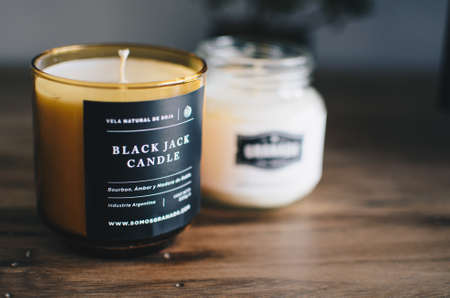 CIUDAD AUTONOMA DE BUENOS AIRES, ARGENTINA - Oct 04, 1991: two white and brown candles over a wood tableのeditorial素材