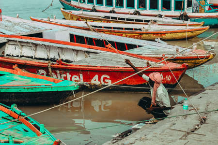 VARANASI, INDIA - Aug 11, 2018: Fisherman, fishing whit handmade tool on Ganges River in Varanasi,...