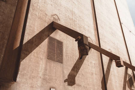 A low angle shot of three metal pipes attached to a concrete wallの写真素材