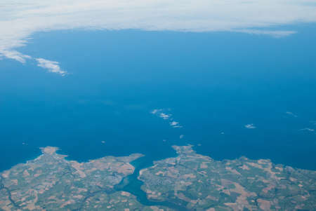 Aerial view of the north Cornwall coastline around Padstow with blue sea and patterned countryside