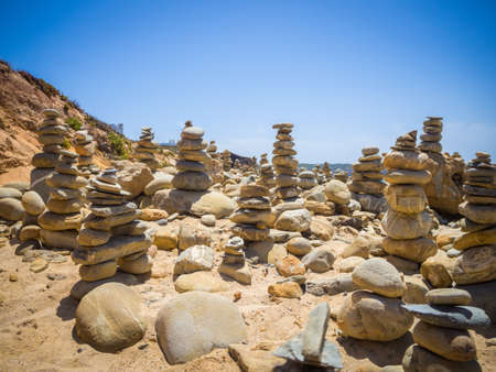 A beautiful scenery of stacks of stones at a bach in mi Fontes, Portugal