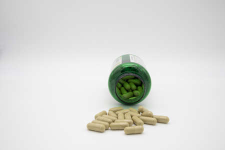 Medication in the form of capsules/pills/tablets against a white backgroundの写真素材