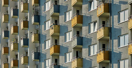 A closeup shot of a modern apartment building in the middle of the city