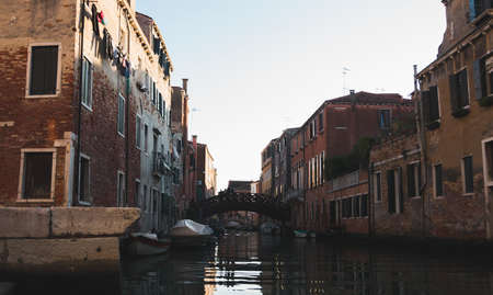 A canal in the middle of buildings in Venice Italyの写真素材
