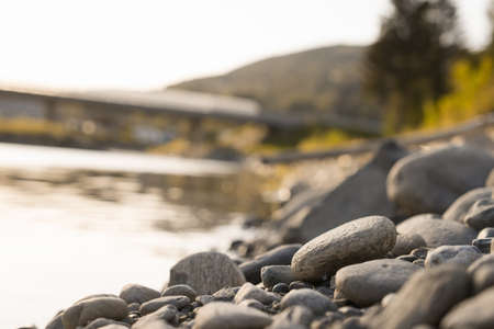 A lot of rocks on the coast of the lake with a blurred backgroundの写真素材