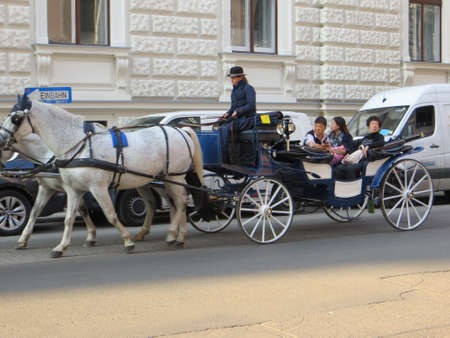 VIENNA, AUSTRIA - Oct 05, 2015: A beautiful shot of people sitting in a blue and white brougham