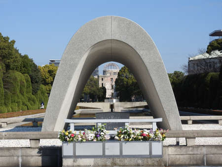 A beautiful shot of a statue with the Atomic Bomb Dome in the distanceのeditorial素材