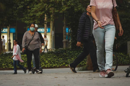 BARCELONA, SPAIN - Apr 06, 2020: People on street during Coronavirus confinement in Barcelona,Spain. Covid 19 Social Distancing.のeditorial素材