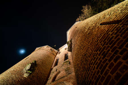 A low angle shot of Koornmarktspoort, the city gate in Kampen, Overijssel the Netherlands and the moonのeditorial素材
